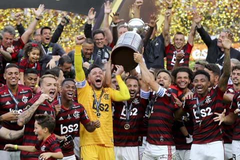 Players of Brazil's Flamengo celebrate with the trophy after defeating 2-1 Argentina's River Plate to win the Copa Libertadores final soccer match at the Monumental stadium in Lima, Peru on Saturday.