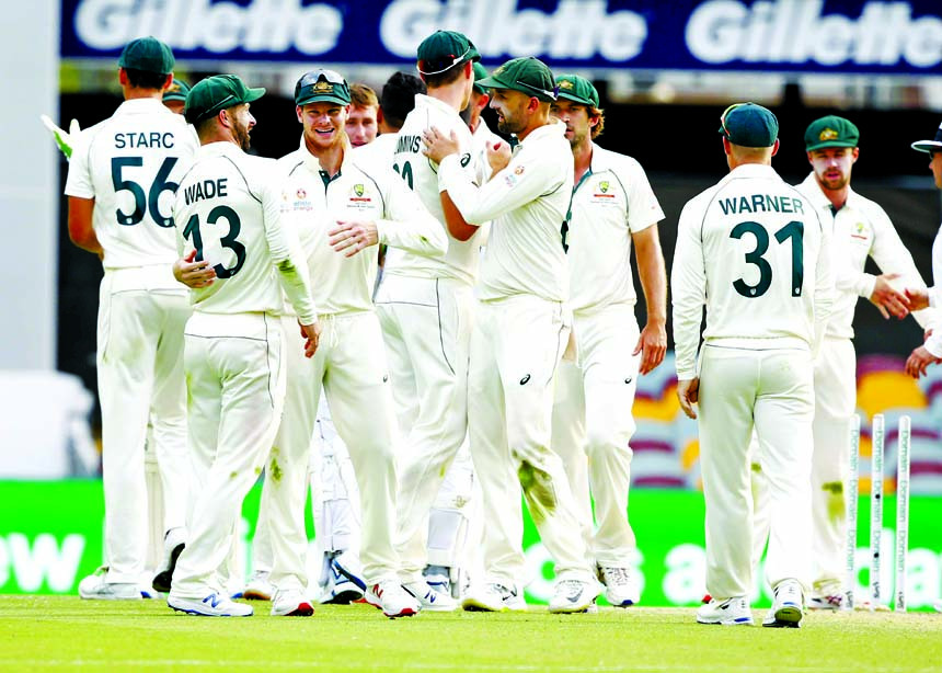 Players of Australia celebrate winning the first Test against Pakistan during their cricket Test match in Brisbane, Australia on Sunday.