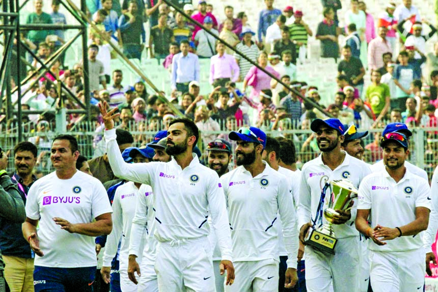 India's captain Virat Kohli leads his team in a victory lap after winning the second match and Test series against Bangladesh in Kolkata, India on Sunday.