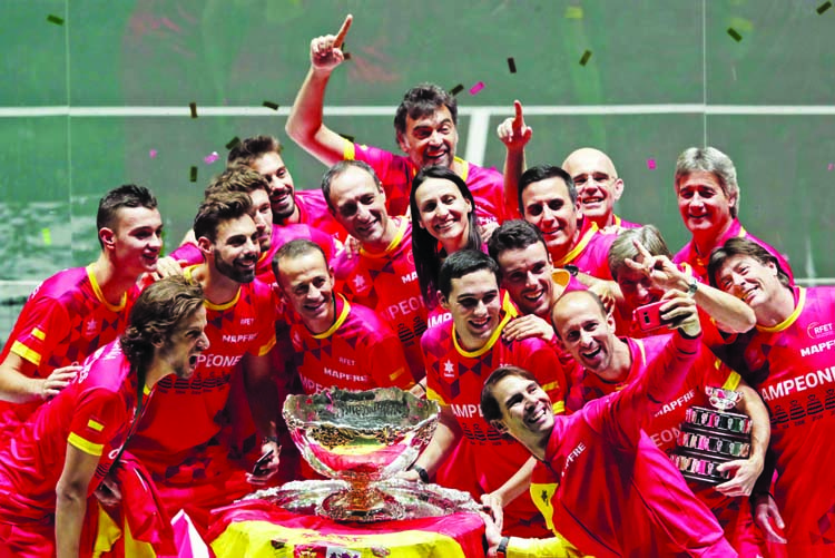 Spain's Rafael Nadal, foreground, takes a selfie with fellow players and team staff posing with the trophy after Spain defeated Canada 2-0 to win the Davis Cup final in Madrid, Spain on Sunday.