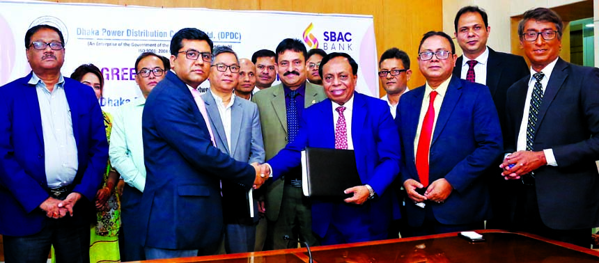 Md. Golam Faruque, Managing Director of South Bangla Agriculture and Commerce (SBAC) Bank Limited Bank and Md. Asaduzzaman, Company Secretary of Dhaka Power Distribution Company (DPDC) Limited, shaking hands after signing an agreement at the DPDC's confe