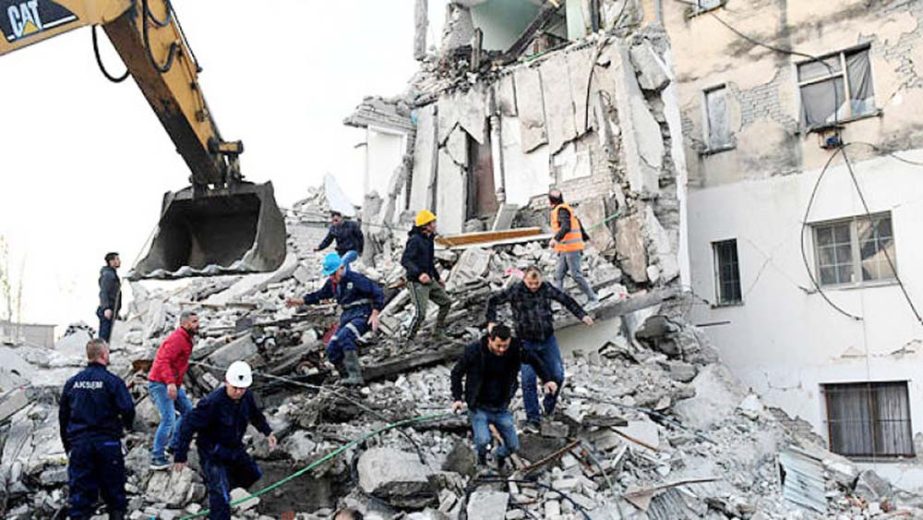 Emergency workers clear debris at a damaged building in Thumane, 34 km northwest of capital Tirana, after an earthquake hit Albania.