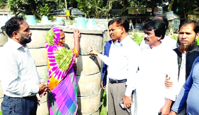 MANIKGANJ: Md Nurul Islam Raja, Chairman, Daulatpur Upazila Parishad distributing sanitary latrine rings among the poor people organised by Adventist Development and Relief Agency (ADRA) Bangladesh, Daulatpur Upazila Branch recently.