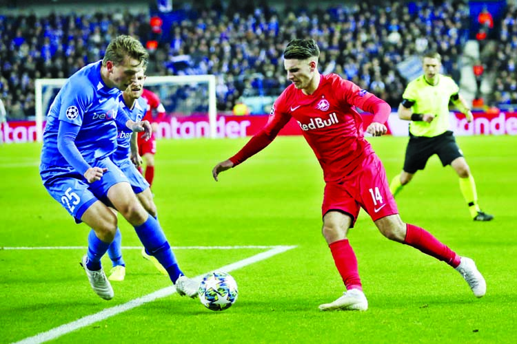 Salzburg's Dominik Szoboszlal (right) vies for the ball with Genk's Sander Berge during a Champions League Group E soccer match between Genk and Salzburg at the KRC Genk Arena in Genk, Belgium on Wednesday.