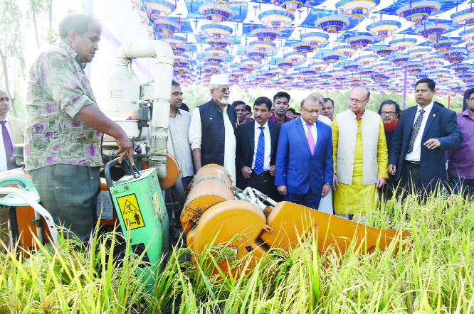 BOGURA: Local Government Minister Md Tajul Islam MP inaugurating harvesting of paddy which was cultivated on cooperative basis at Garidah Union in Bogura Sadar Upazila on Tuesday.
