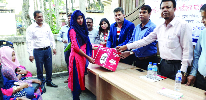MOULVIBAZAR: Shariful Islam, UNO, Moulvibazar Sadar Upazila distributing sewing machines among the girls after a 15 - day-long training course at Centre for Natural Resources Studies (CNRS) Office organised by CNRS on Thursday.
