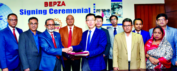 Zillur Rahman, Member (Investment Promotion) of BEPZA and Sha ShiJun, Managing Director of Ms. Oscar Bangla Company Limited, exchanging documents after signing an agreement at BEPZA head office in the city recently. Under the deal, the Oscar Bangla Co.,