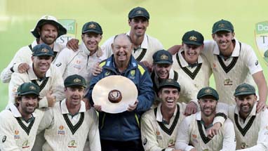 The Australian team celebrate with the trophy after Australia defeated Pakistan on the fourth day of the second cricket Test match in Adelaide on Monday.