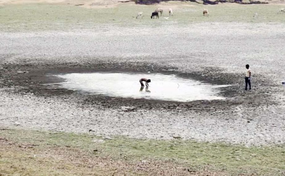 A boy catches fish in a dried-up pond near the banks of the Ganges river Allahabad, India. India's Earth Sciences Minister has blamed climate change for severe heatwave that has killed 2,500 people and for deficient monsoon rains, the country was headed