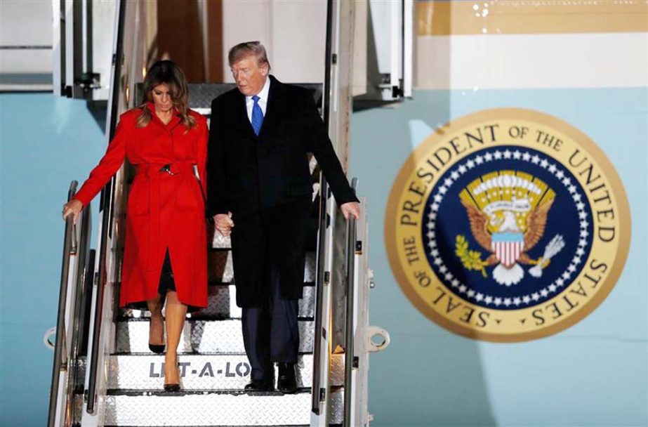 US President Donald Trump and First Lady Melania Trump disembark Air Force One after landing at Stansted Airport, northeast of London on Monday.