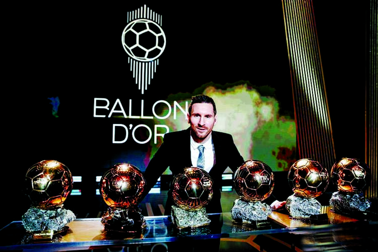 Barcelona's soccer player Lionel Messi poses with his six golden balls during the Golden Ball award ceremony in Paris on Monday.