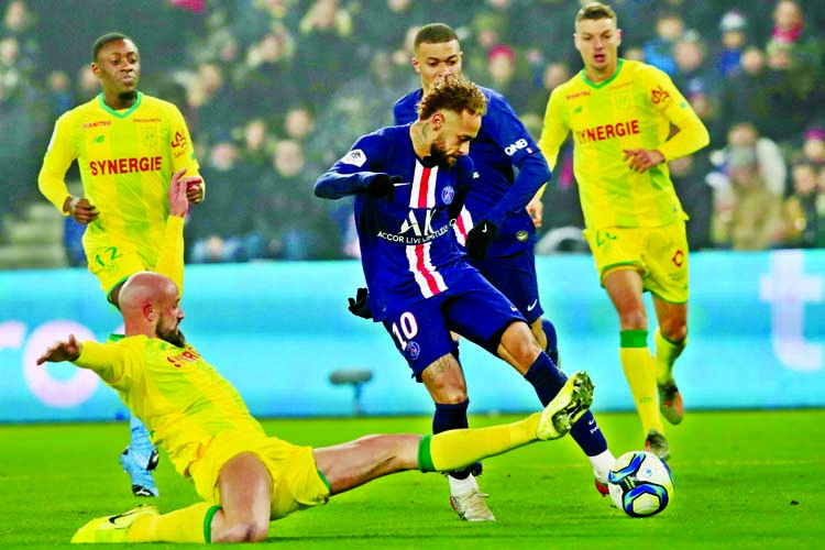 PSG's Neymar (center) is tackled by Nantes Nicolas Pallois during the French League One soccer match between PSG and Nantes at the Parc des Princes stadium in Paris on Wednesday.