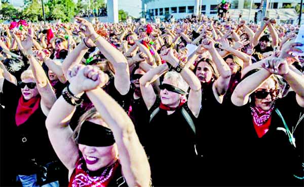 Feminist activists take part in a choreographed performance against gender violence, patriarchy and denounce an oppressive state, outside the national stadium -used as clandestine detention center during Augusto Pinochet's military coup- in Santiago.