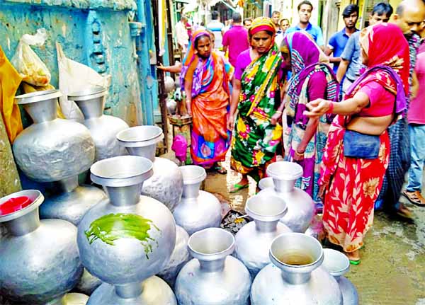 Local people collect drinking water from a WASA pump at Pannitola in old town of Dhaka amid a crisis of supply water in the area. The photo was taken on Friday.
