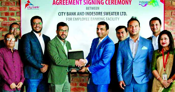 Md. Abdul Wadud, DMD of City Bank Limited and Mohammed Rokunuzzaman Milon, Chairman of Indesore Sweater Limited, exchanging an agreement signing document at the garment's head office in Gazipur recently. High officials from both the organizations were pr