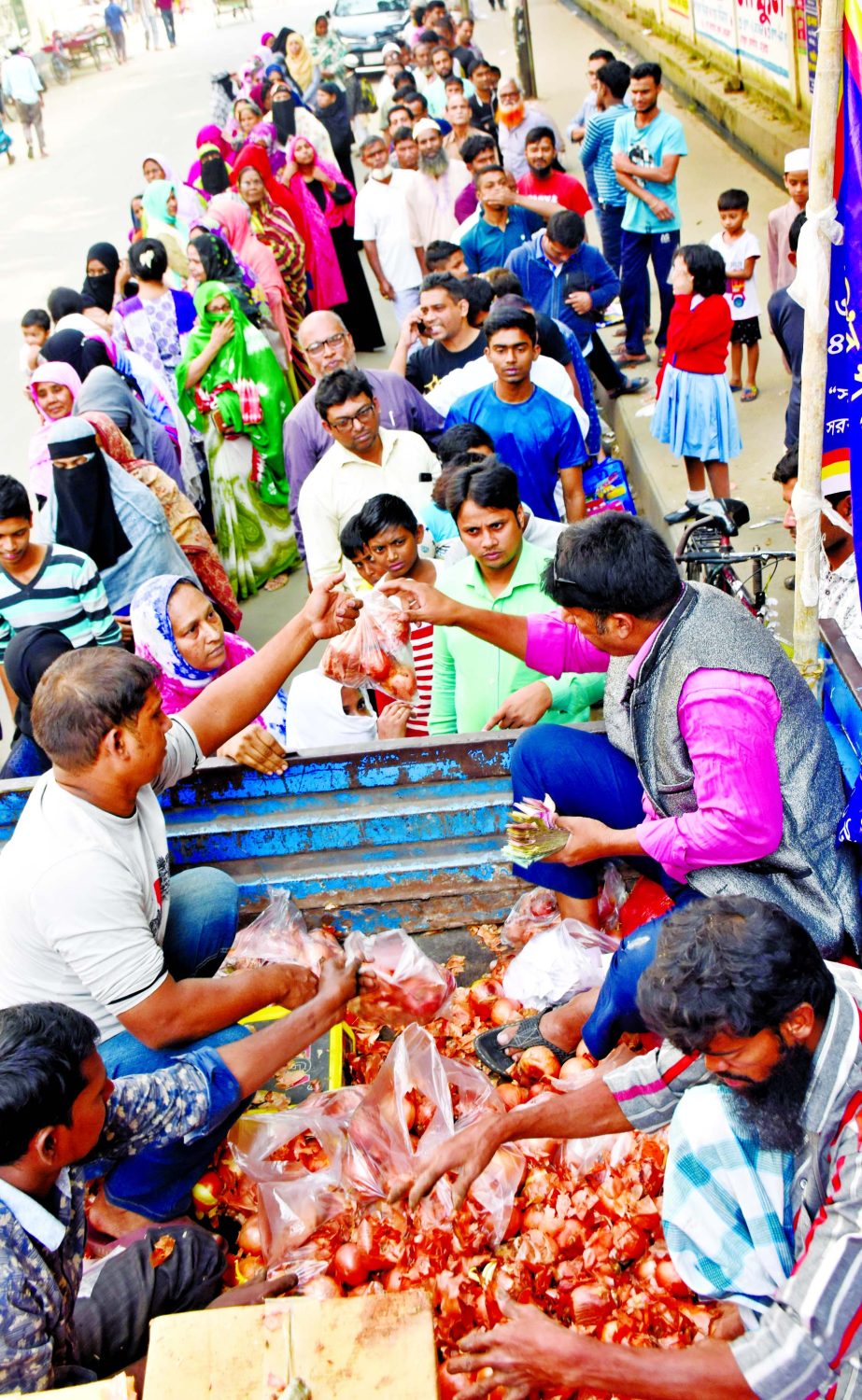 Consumers continue to form long queues to get onions at Tk 45 per kg sold by Trading Corporation of Bangladesh (TCB) at various points in the city as the prices of the key kitchen staple is still unstable. This photo was taken from in front of Azimpur Chh