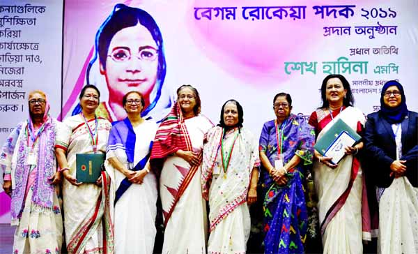 Prime Minister Sheikh Hasina in a photo session with the recipients of Rokeya Padak after handing over those marking the Begum Rokeya Day on Monday at Osmani Memorial Auditorium.
