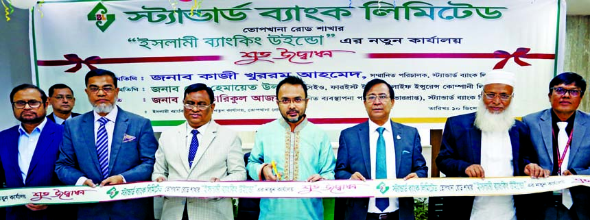 Kazi Khurram Ahmed, Director of Standard Bank Limited, inaugurating its new office of Islamic Banking Window in city's Topkhana Road Branch on Tuesday. Md. Tariqul Azam, Managing Director (acting), Md. Motaleb Hossain, DMD of the bank and Md. Hemayet Ull