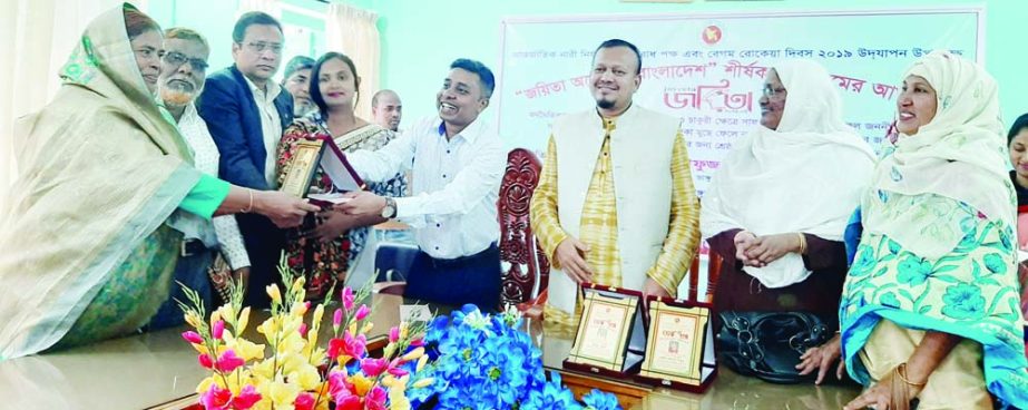 BHANGURA (Pabna): Syed Asrafujjaman, UNO and Md Baki Billah, Chairman, Upazila Parishad distributing the medal among the winners of Begum Rokeya Padak at Bhangura Upazila Parishad Hall Room marking the Rokeya Day on Monday.