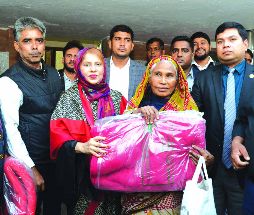 Parveen Haque Sikder, M.P, Director along with Zainul Haque Sikder, Chairman and Monowara Sikder, Director of National Bank Limited, distributing blankets to the poor distressed people on the occasion of the death anniversary of late Mokfor Uddin Sikder,