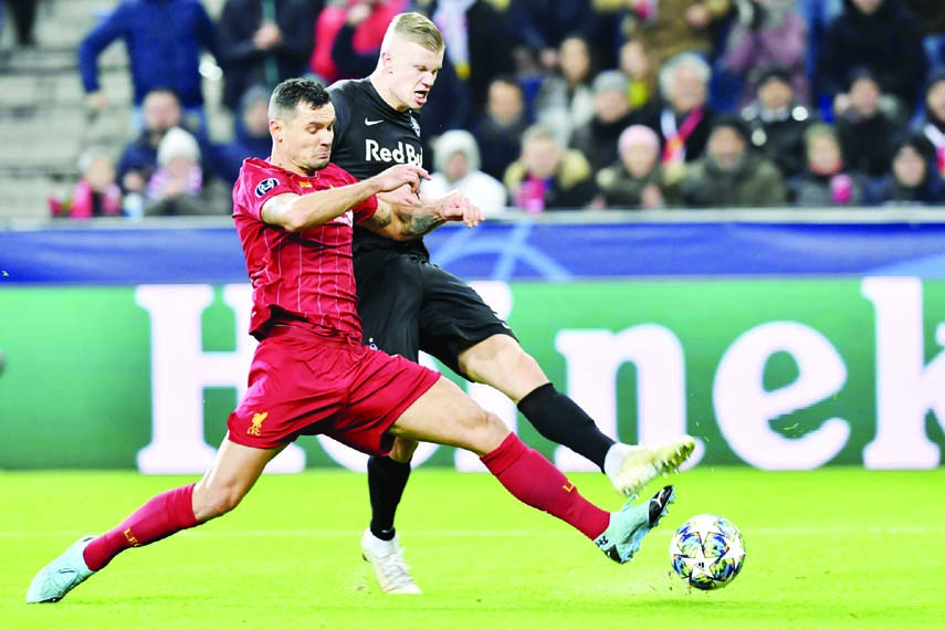 Salzburg's Erling Braut Haland (right) fights for the ball with Liverpool's Dejan Lovren during the group E Champions League soccer match between Salzburg and Liverpool, in Salzburg, Austria on Tuesday.