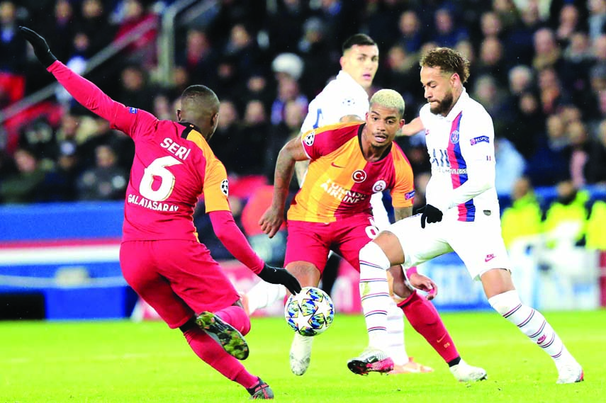 PSG's Neymar (right) challenges for the ball with Galatasaray's Mario Lemina (center) and Galatasaray's Jean Michael Seri, during the Champions League Group A soccer match between PSG and Galatasaray, at the Parc des Princes stadium in Paris on Wednesd