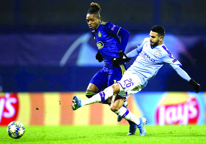 Manchester City's Riyad Mahrez (front) duels for the ball with Dinamo Zagreb's Francois Moubandje during the Champions League Group C soccer match between Dinamo Zagreb and Manchester City at Maksimir Stadium in Zagreb, Croatia on Wednesday.