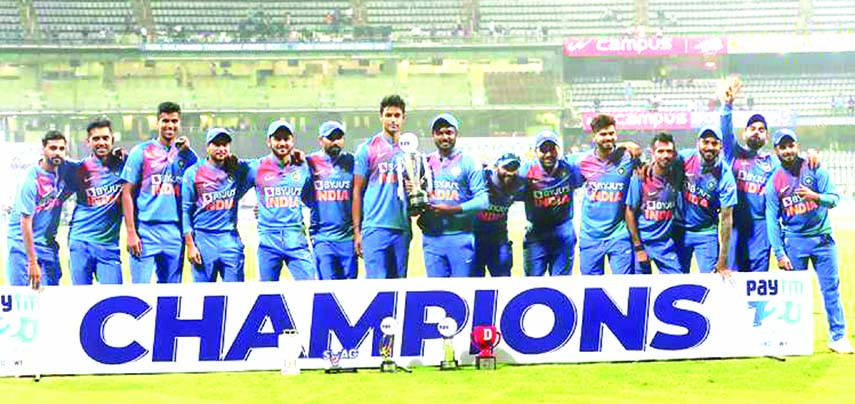 Players of Indian cricket team pose with the winner's trophy after their win in the third Twenty20 international cricket match against West Indies at the Wankhede Stadium in Mumbai on Wednesday.