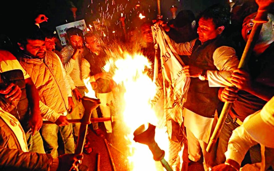 Members of the youth wing of India's main opposition Congress party burn a copy of Citizenship Amendment Bill, a bill that seeks to give citizenship to religious minorities persecuted in neighbouring Muslim countries, during a protest in New Delhi, India