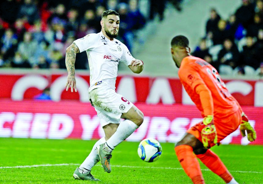 Montpellier's Andy Delort (left) controls the ball and scores during the French League One soccer match between Lille and Montpellier at the Lille Metropole stadium, in Villeneuve d'Ascq, Northern France on Friday.