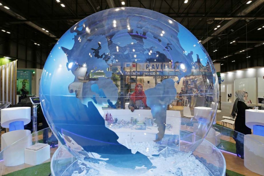 A woman looks at a World globe at the COP25 climate talks congress in Madrid, Spain, on Friday. Officials from almost 200 countries are scrambling to reach an agreement at a United Nations climate meeting amid growing concerns that key issues may be postp