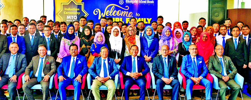 Akkas Uddin Mollah, Chairman, Board of Directors of Shahjalal Islami Bank Limited, poses for photograph with the participants of a induction ceremony for its newly recruited Management Trainee Officer at the bank's corporate head office in the city on Sa