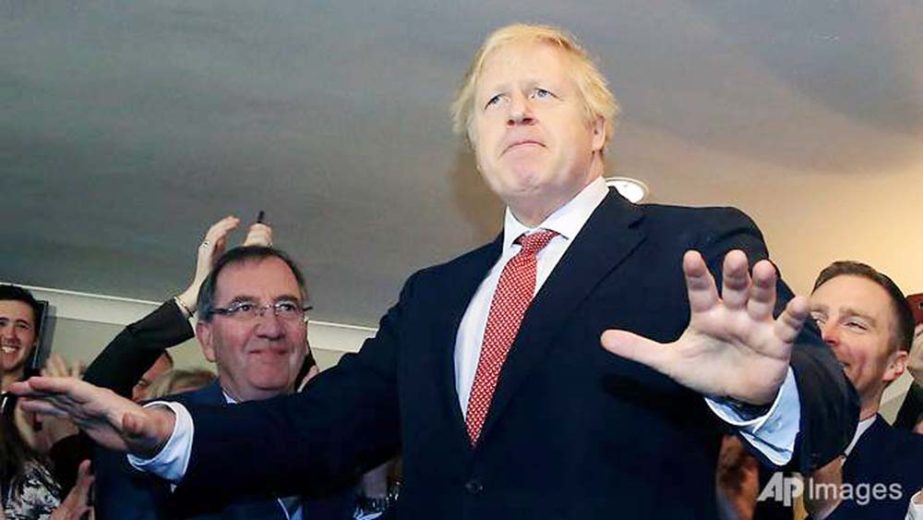 Britain's Prime Minister Boris Johnson gestures as he speaks to supporters on a visit to meet newly elected Conservative party MP for Sedgefield, Paul Howell, at Sedgefield Cricket Club in County Durham, north east England.