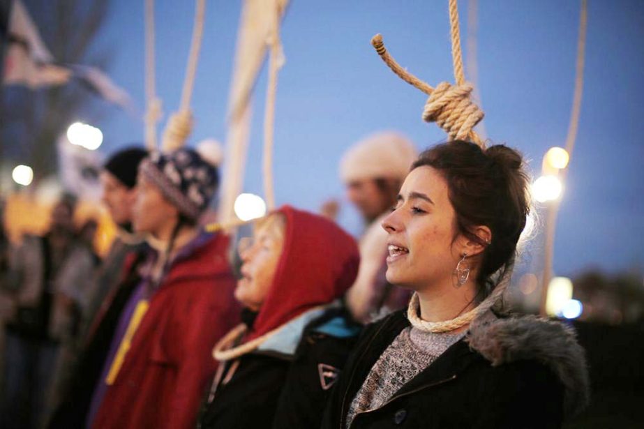 Activists protest outside of the COP25 climate talks congress in Madrid, Spain on Saturday. The United Nations Secretary-General has warned that failure to tackle global warming could result in economic disaster.