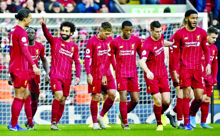 Liverpool's Mohamed Salah (3rd left) celebrates with teammates after scoring his sides first goal during the English Premier League soccer match between Liverpool and Watford at Anfield stadium in Liverpool, England on Saturday.