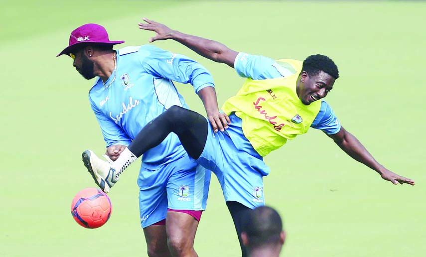 West Indies' captain Kieron Pollard (left) and Hayden Walsh collide as they fight for the ball during a friendly game of soccer at a training session ahead of their second One Day International cricket match against India, in Visakhapatnam, India on Tues