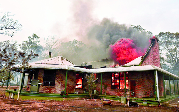 A property burns from bushfires in Balmoral, 150 kilometres southwest of Sydney.