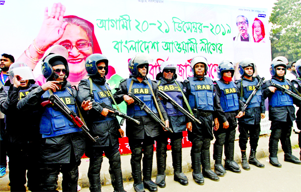 Law enforcers stand guard for security measures on the occasion of national council of Bangladesh Awami League. The snap was taken from the western side of the city's Suhrawardy Udyan on Friday.