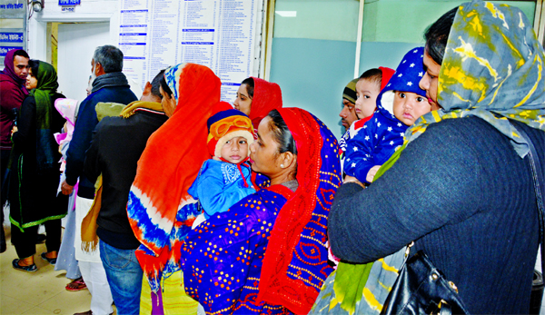 Women lined up with their ailing children at the out-door patient department (OPD) of Dhaka Shishu Hospital on Friday as falling temperature caused by the mild cold wave contribute to sudden rise in patients with cold-related illness at public hospitals a