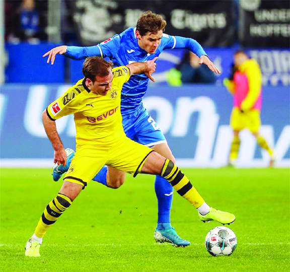 Mario Gotze (left) vies with Robert Skov of Hoffenheim during a German Bundesliga match between Borussia Dortmund and TSG 1899 Hoffenheim in Hoffenheim, Germany on Friday.