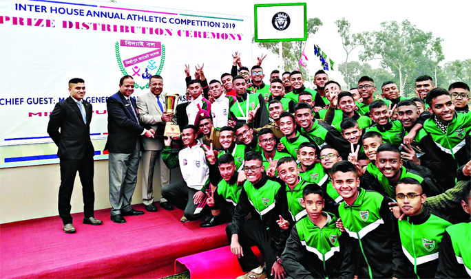 Chief guest GOC of Ninth Infantry Division of Savar Cantonment Major General Md Akbar Hossain handing over the champions trophy to Nazrul House, which emerged as the champions in the Inter-House Annual Sports Competition of Tangail Mirzapur Cadet College