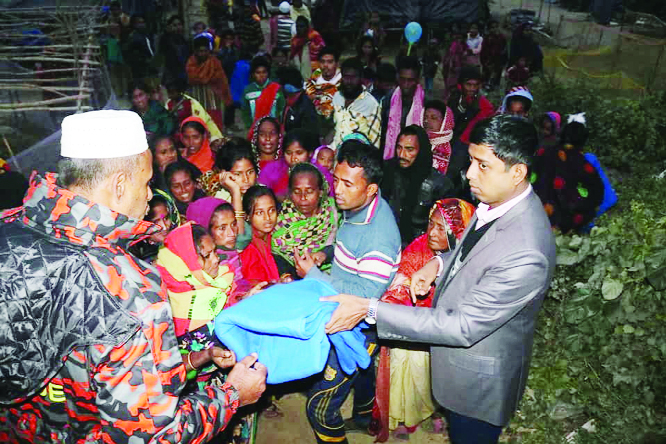 BAHCHARAMPUR (Brahmanbaria): Md Nasir Uddin Sarwar, UNO distributing blankets among the cold -hit people organised by Upazila Administration on Saturday.