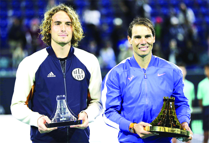 Rafael Nadal from Spain (right) stands next to Stefanos Tsitsipas of Greece, celebrates after Nadal won the final match of the Mubadala World Tennis Championship in Abu Dhabi, United Arab Emirates on Saturday.
