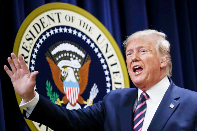 U.S. President Donald Trump waves after speaking at a White House Mental Health Summit in the South Court Auditorium of the Eisenhower Executive Office Building at the White House in Washington, DC.