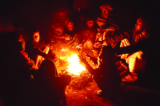 BOGURA: People at Bogura Railway Station burning straws to get rid of cold wave on Sunday night.