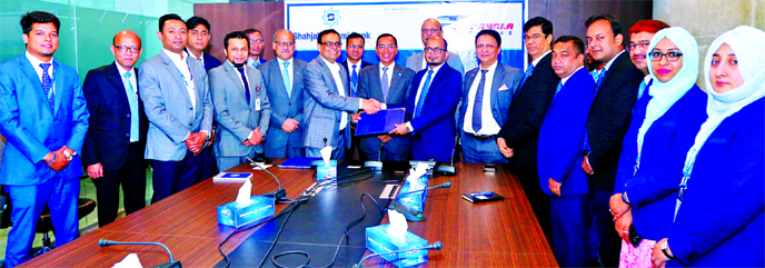 Md. Marufur Rahman Khan, Head of Card Division of Shahjalal Islami Bank Limited and Md. Shafiqul Islam, Head of Marketing & Sales of US-Bangla Airlines, exchanging a MoU signing document at the bank's head office in the city on Monday. Under the deal, al