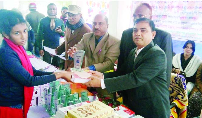 MANIKGANJ: Abdul Monnaf Khan, Assistant Upazila Education Officer , Sibalaya Upazila distributing crest and prizes among the winners of Abdul Hai Scholarship Programme at Mohadevpur Government Primary School on Sunday.