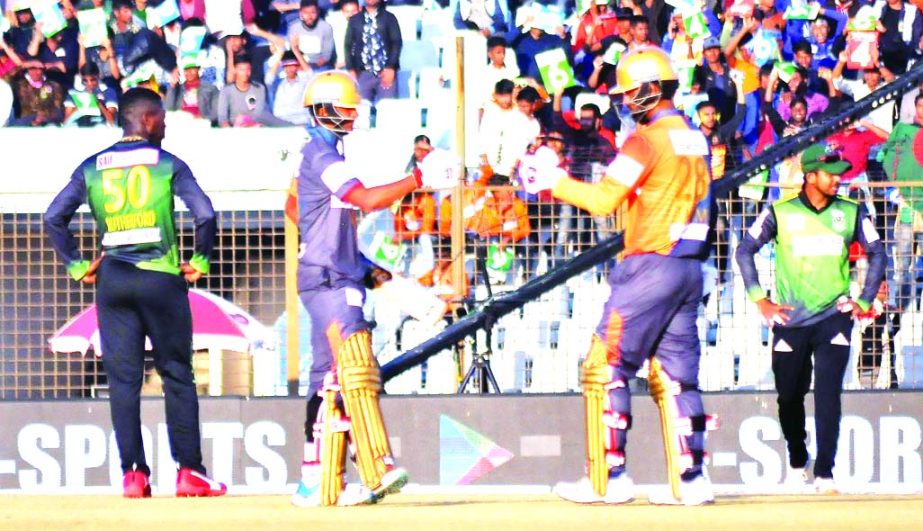 Mahedi Hasan (second from left) and Tamim Iqbal of Dhaka Platoon toasting during their Twenty20 match of the Bangabandhu Bangladesh Premier League (BPL) against Sylhet Thunder at Zahur Ahmed Chowdhury Stadium in Chattogram on Tuesday.