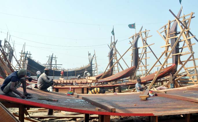 Makers passing busy time in trawler making at Fisheries Ghat of Kornophuli River side. This snap was taken yesterday.