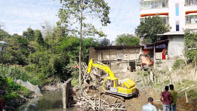 Illegal structures were evicting by Bandarban Water Developmnet Board from Michki canal in Bandarban on Monday.
